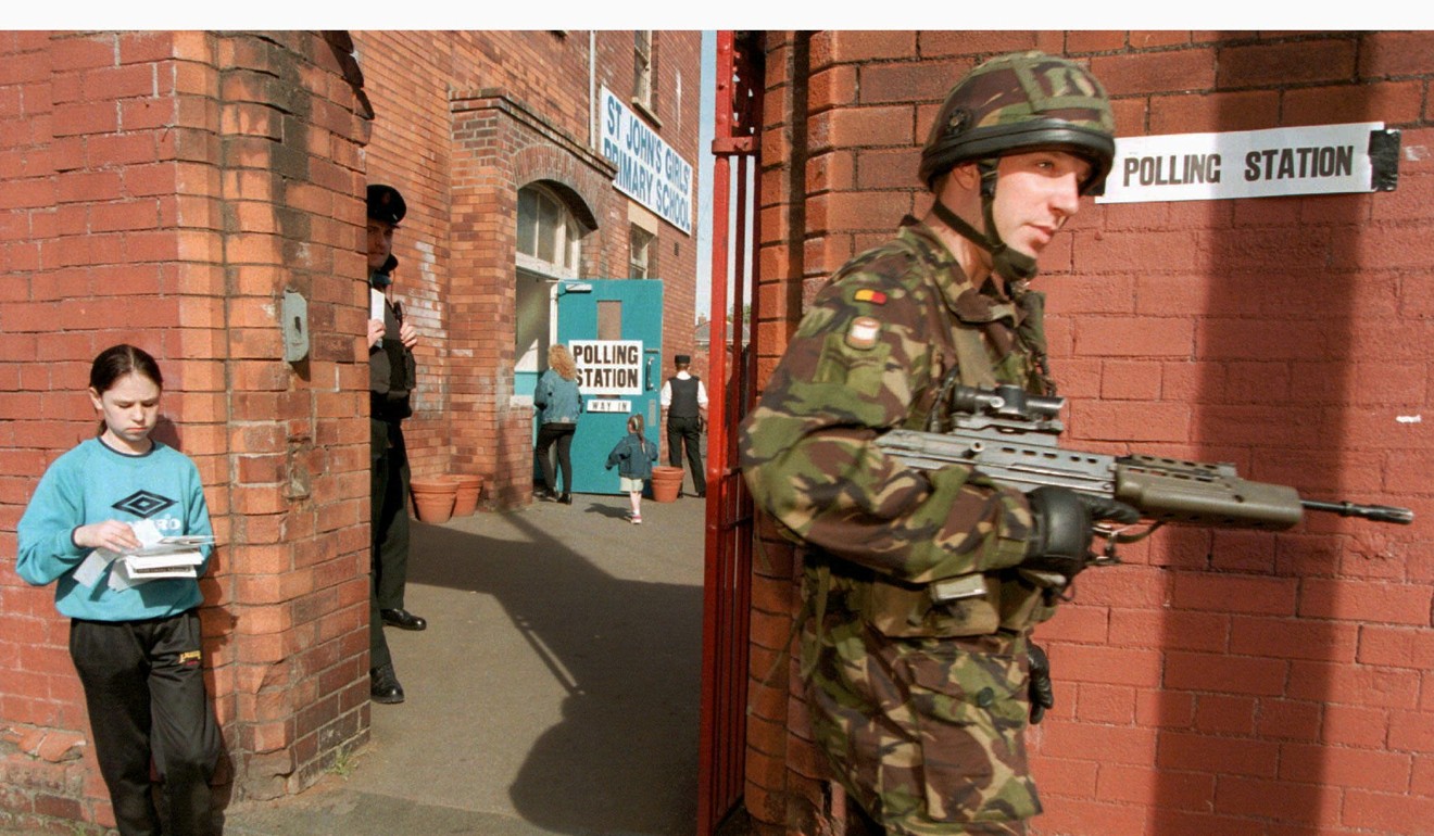 Soldiers and police guard a west Belfast polling station during the 1997 election. Photo: Reuters