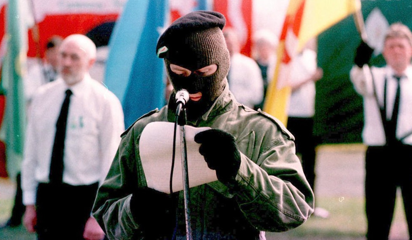 A masked IRA member delivers a message from the militant group’s leadership in April, 1996. Photo: AFP