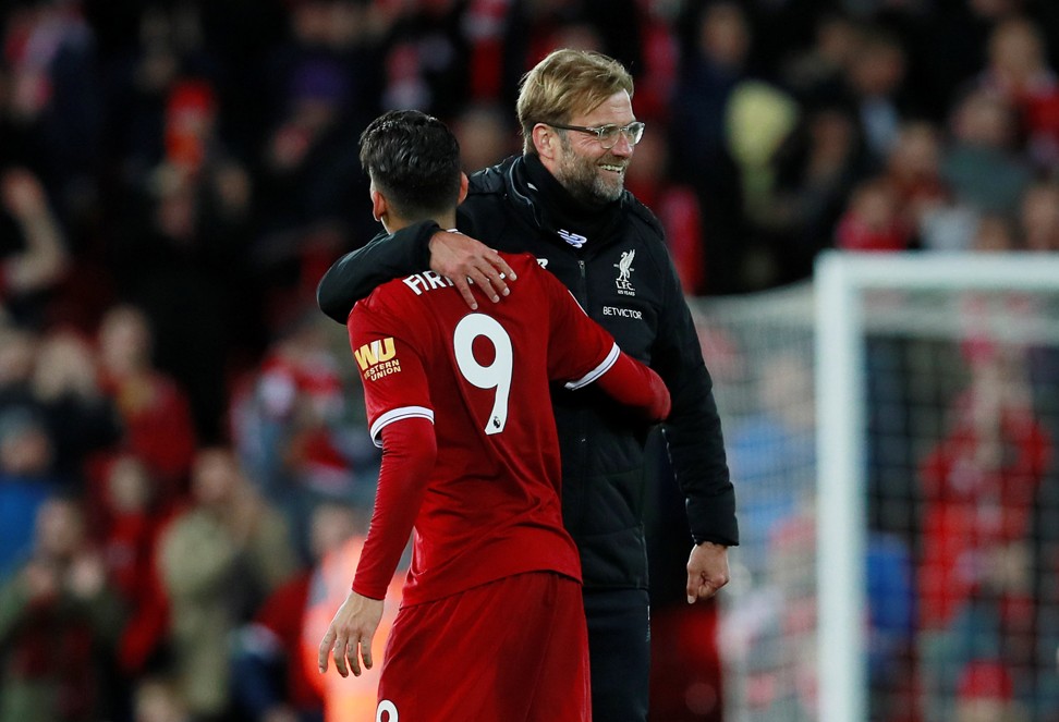 Klopp celebrates with Roberto Firmino after the match. Photo: Reuters