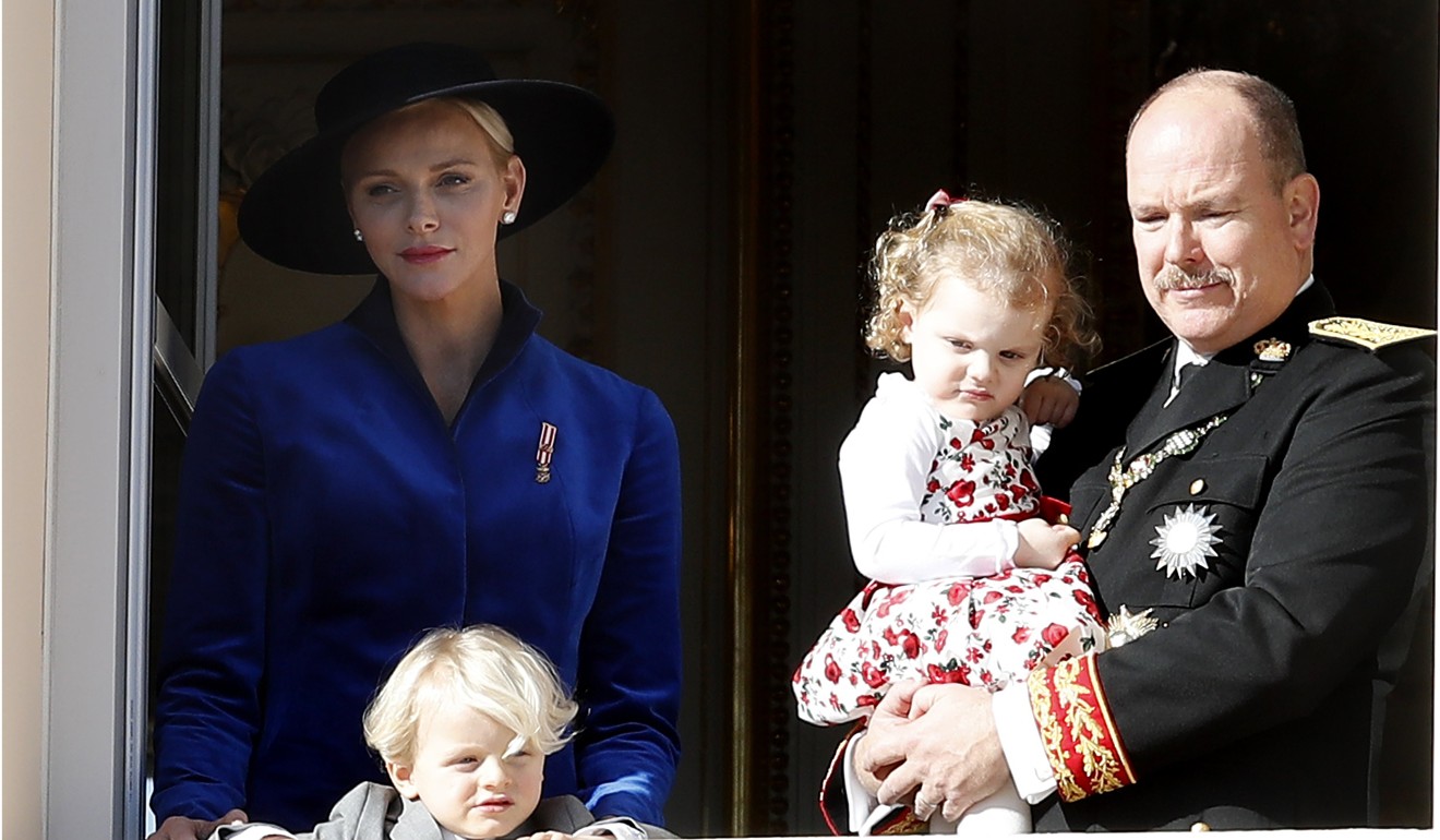 Prince Albert II of Monaco (R) and his wife Princess Charlene (L) with their baby twins Prince Jacques and Princess Gabriella attend the Army Parade, as part of the official celebrations marking the principality's National Day at the Monaco Palace on Sunday. Photo: EPA