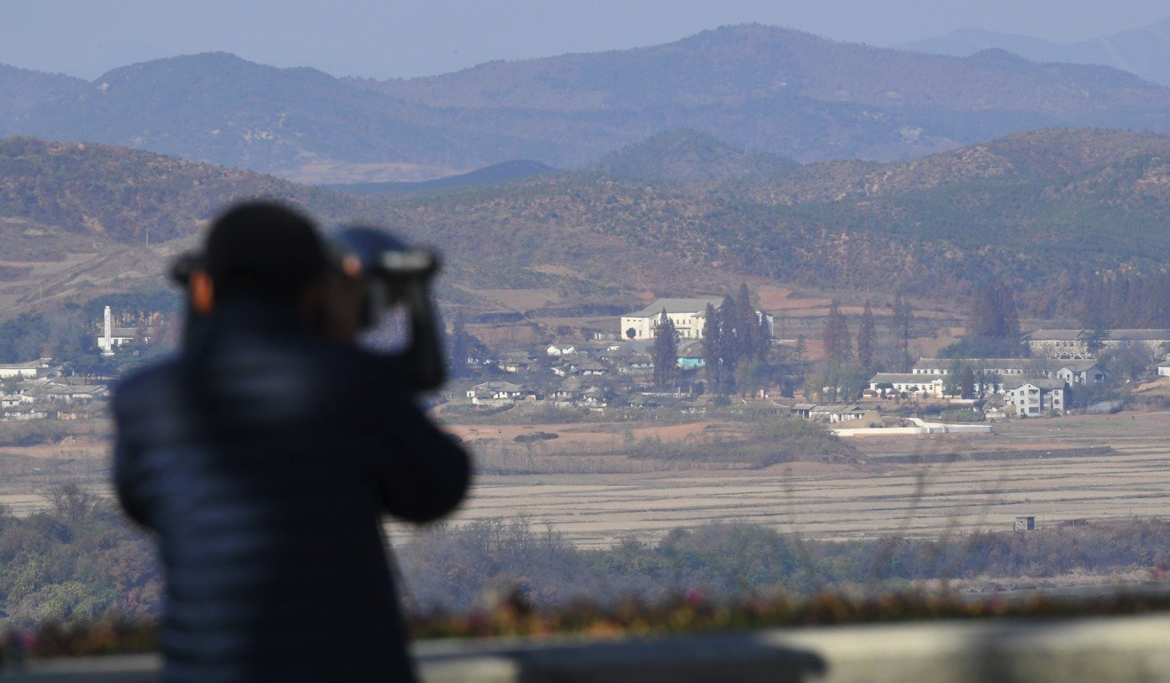 A woman looks through binoculars towards North Korea from a South Korean observation post in Paju near the Demilitarized Zone (DMZ) dividing the two Koreas on November 14. Photo: Agence France-Presse