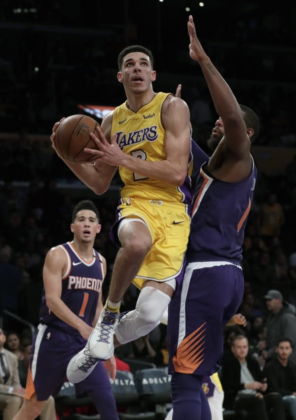 Lakers' Lonzo Ball drives past the Phoenix Suns’ Greg Monroe. Photo: TNS
