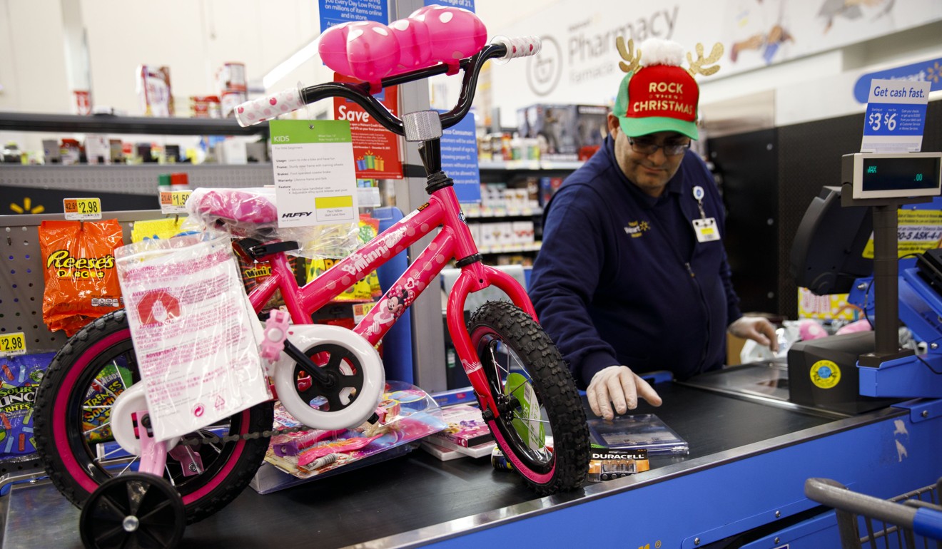 A Wal-Mart employee with a children’s bicycle. Photo: Bloomberg
