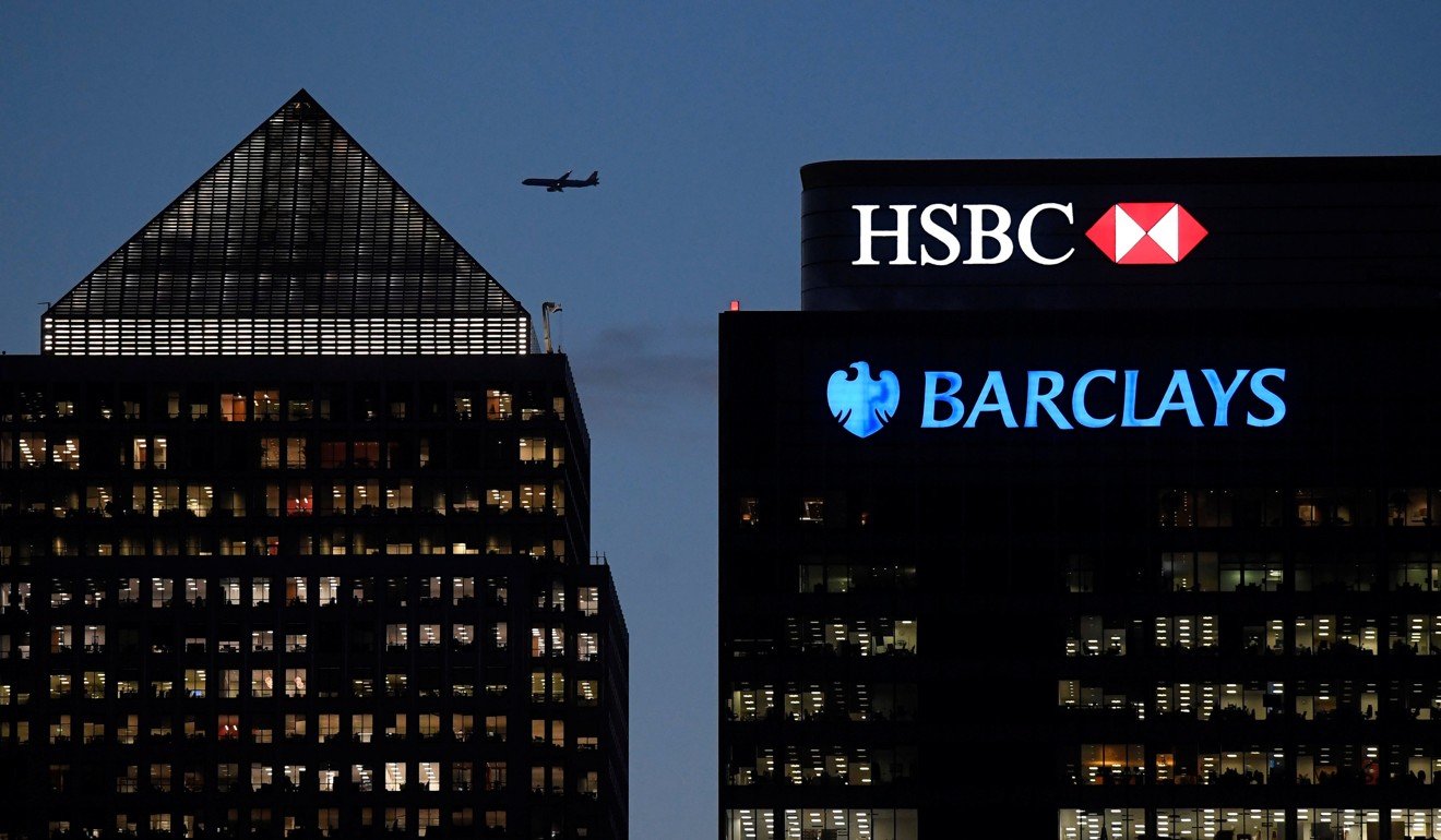 Workers are seen in offices of HSBC and Barclays bank in the Canary Wharf financial district at dusk in London, Britain. Photo: Reuters