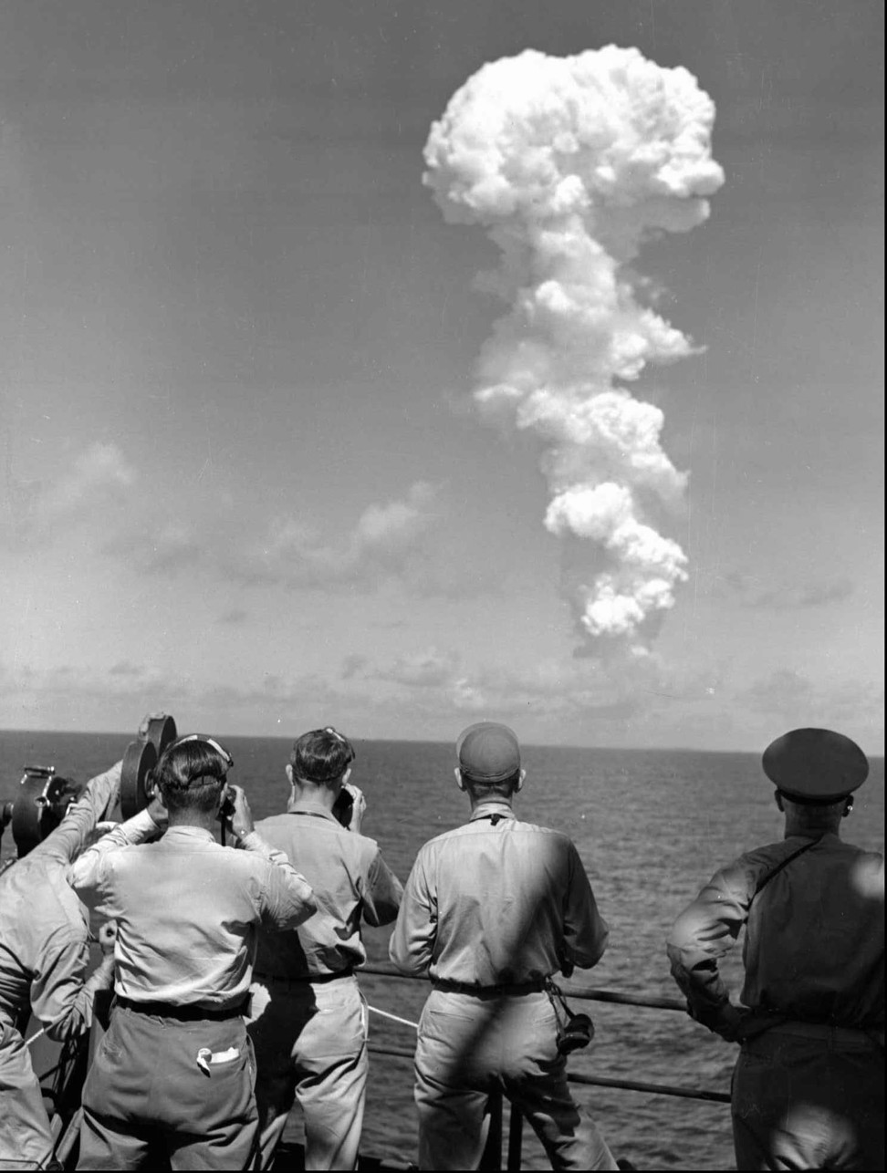 Photographers and observers on the bridge of the USS Mount McKinley watch a huge cloud mushroom over Bikini Atoll in the Marshall Islands on July 1, 1946, following an atomic test. Bikini Atoll would, in 1954, be the site of the world’s first hydrogen bomb test, and the islands are still considered uninhabitable today. Photo: AP