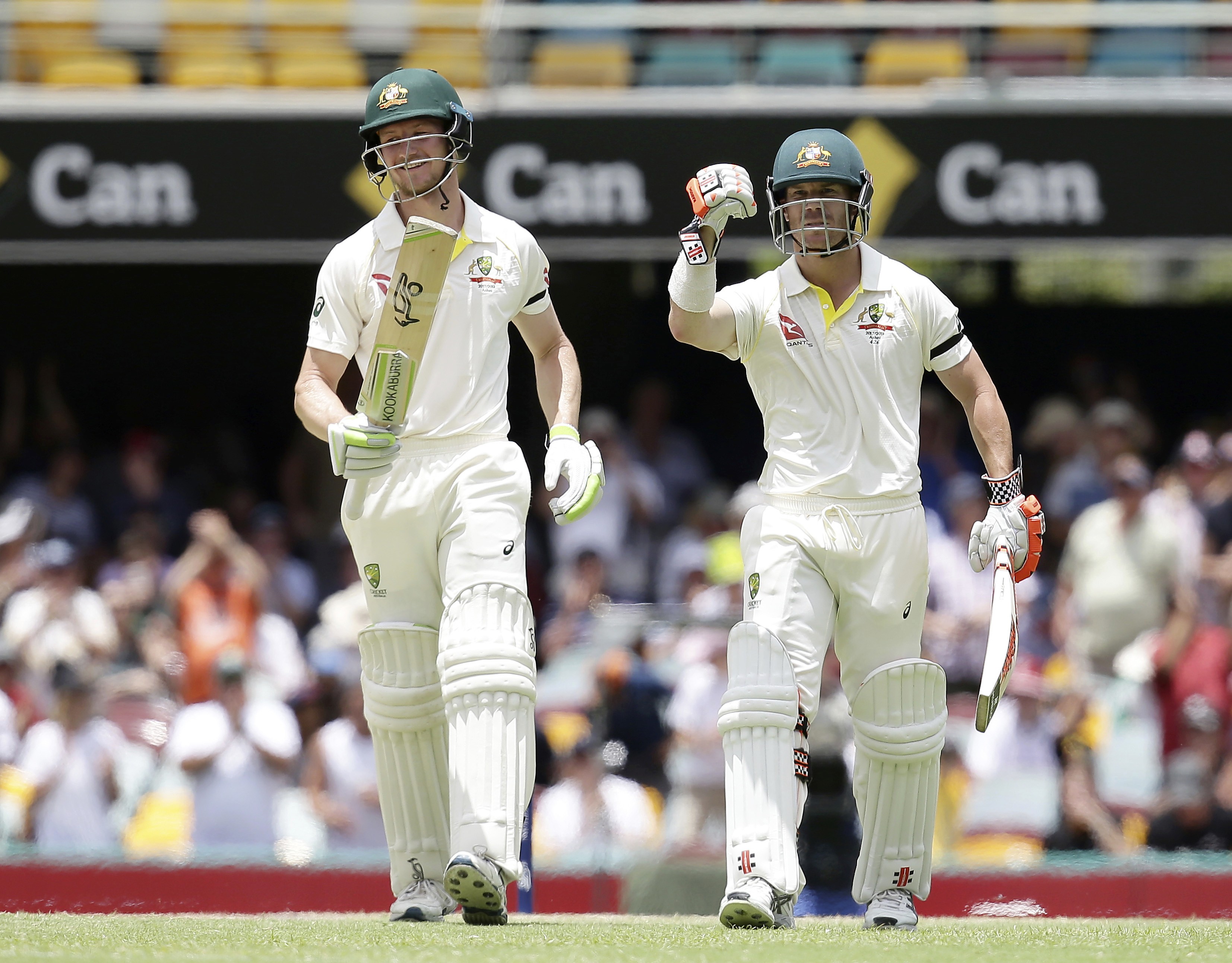 Australia’s David Warner(R) and Cameron Bancroft walk off the field after winning the opening test match against England. Photo: AP