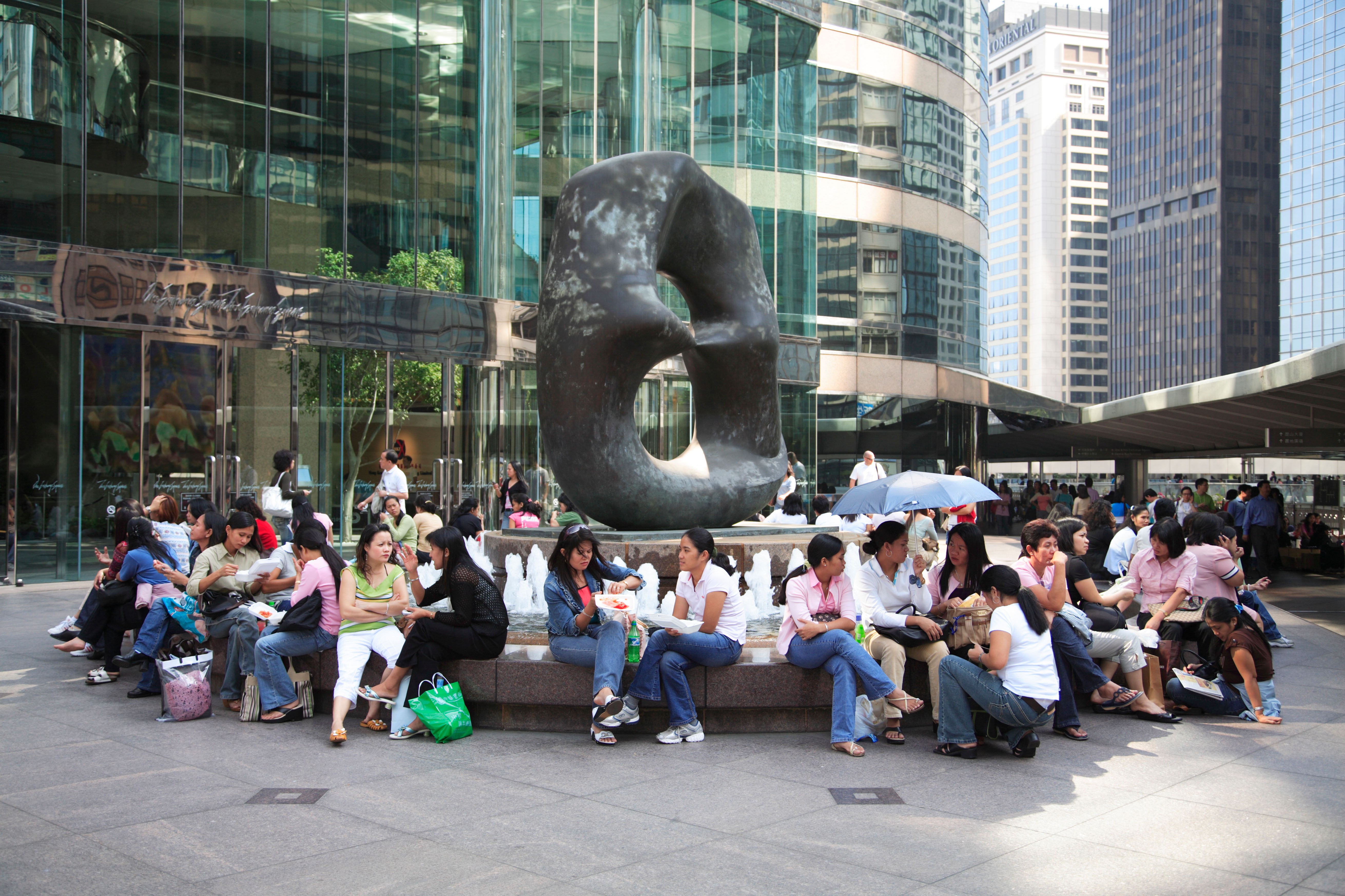 Domestic Helpers from the Philippines enjoy time off at Exchange Square in Central. Photo: Alamy