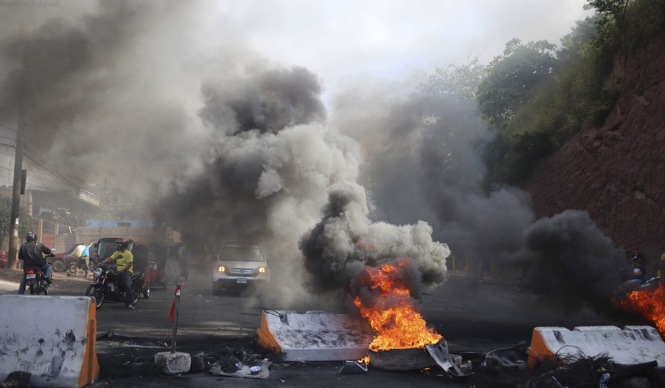 Protesters set fires, looted businesses and built barricades in the wake of the Honduras presidential election. Photo: EPA