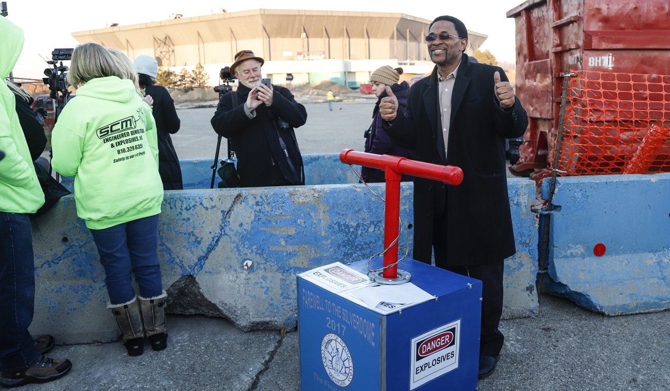 Dwayne Lyons, City of Pontiac's community relations specialist and arts commissioner, poses for a photo with a fake TNT box outside the Silverdome. Photo: TNS