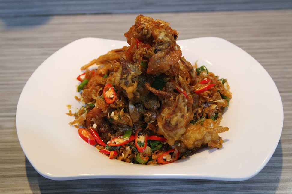 Deep-fried soft shell crab with crispy garlic, white pepper and spring onion. Photo: Roy Issa