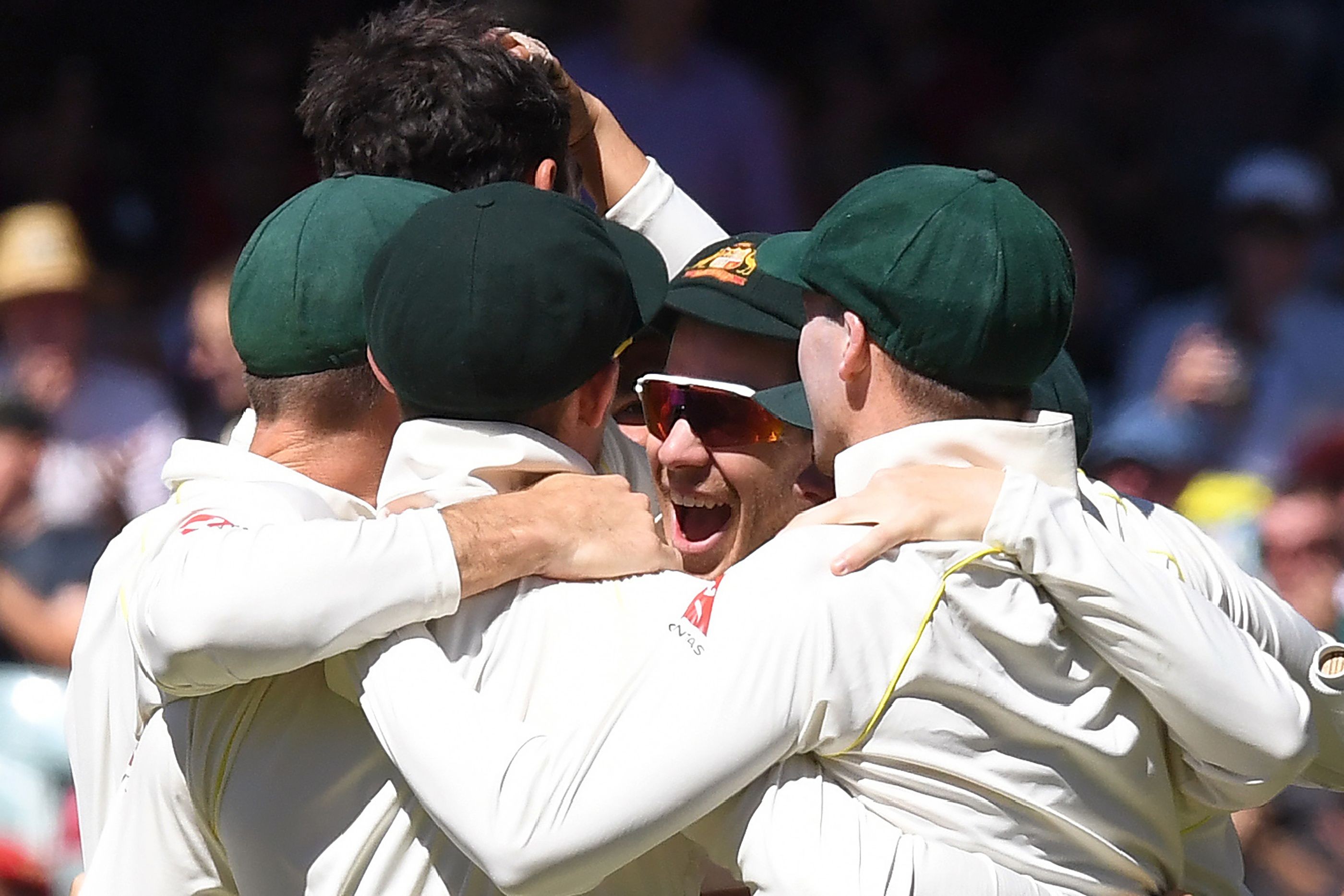 Australia’s players celebrating after they defeated England on the final day of the second Ashes test in Adelaide. Photo: AFP