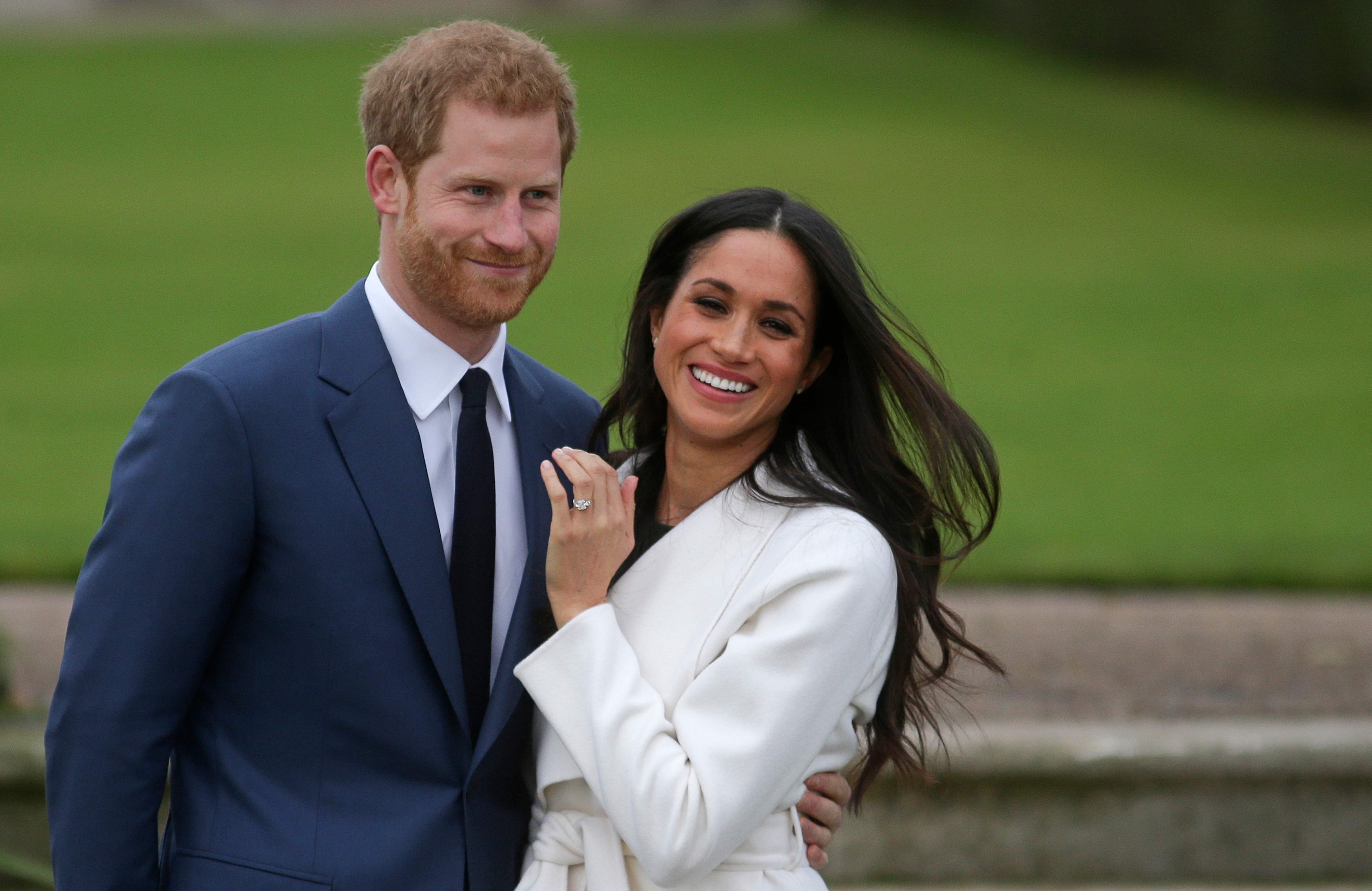Britain’s Prince Harry stands with his fiancée, US actress Meghan Markle, as she shows off her engagement ring following the announcement of their betrothal on November 27. The couple are expected to get married in May next year. Photo: AFP