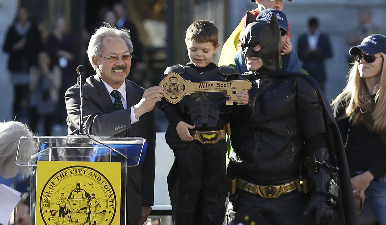 San Francisco Mayor Ed Lee presents the key to the city to young Miles Scott. Lee died on Tuesday after collapsing at a supermarket. Photo: AP