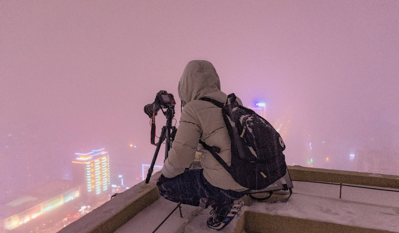 Li Bai goes rooftopping on a snowy night in Harbin, Heilongjiang. The experience has changed his outlook on life, he says. Photo: Li Bai