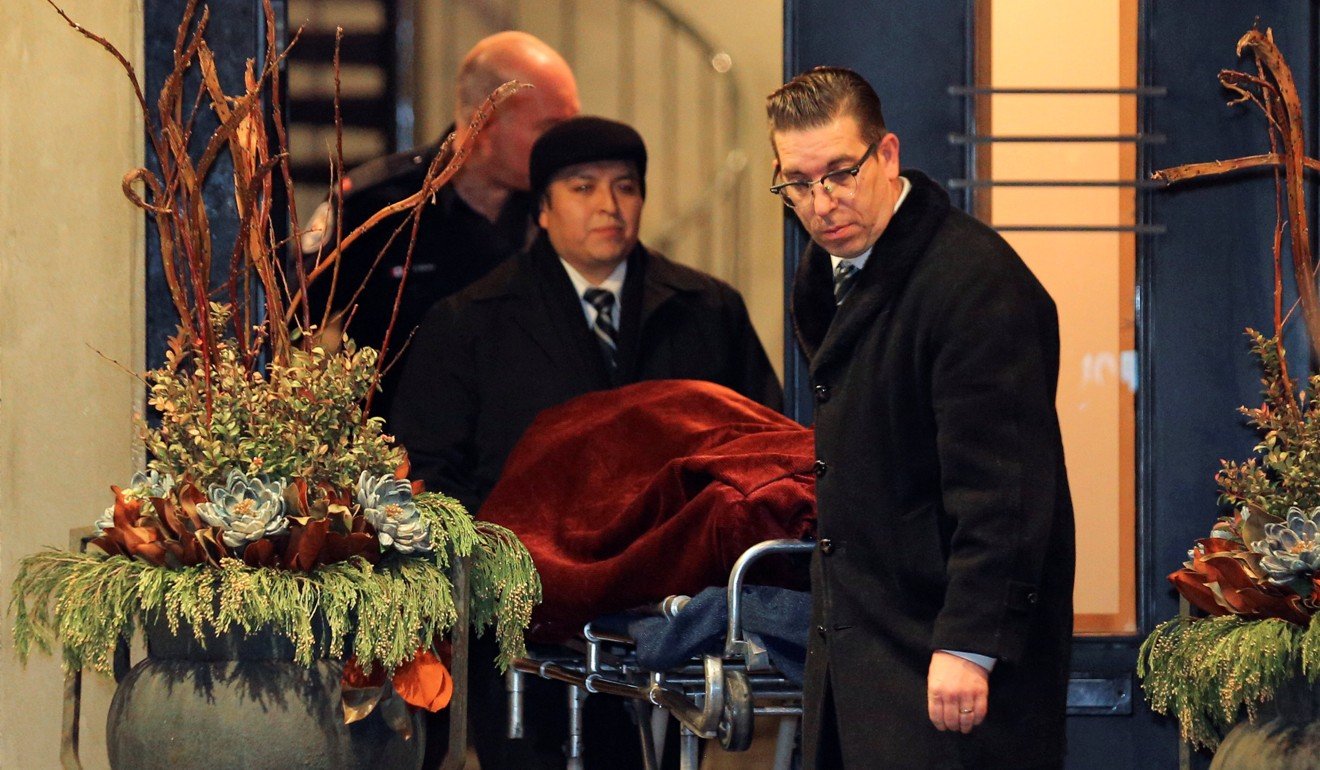 One of two bodies is removed from the home of Barry Sherman and his wife Honey in Toronto on Saturday. Photo: Reuters