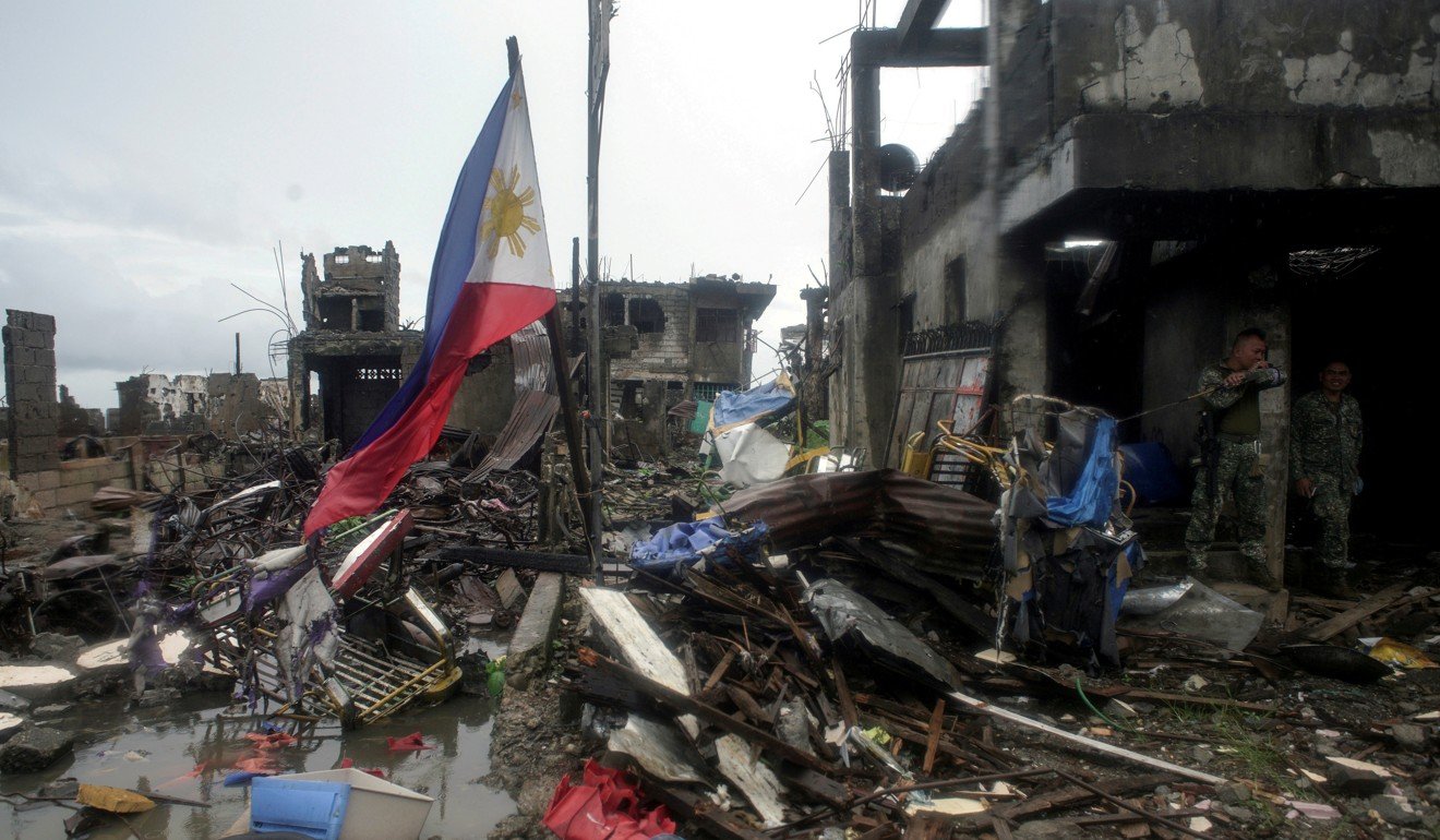 A Philippine flag seen standing among the rubble left over from the armed conflict in Marawi city, southern Philippines. Photo: Reuters