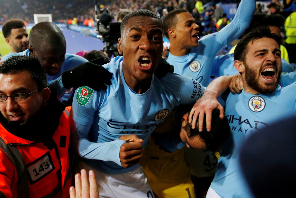 Manchester City players celebrate with the away fans after winning the penalty shoot-out. Photo: Reuters