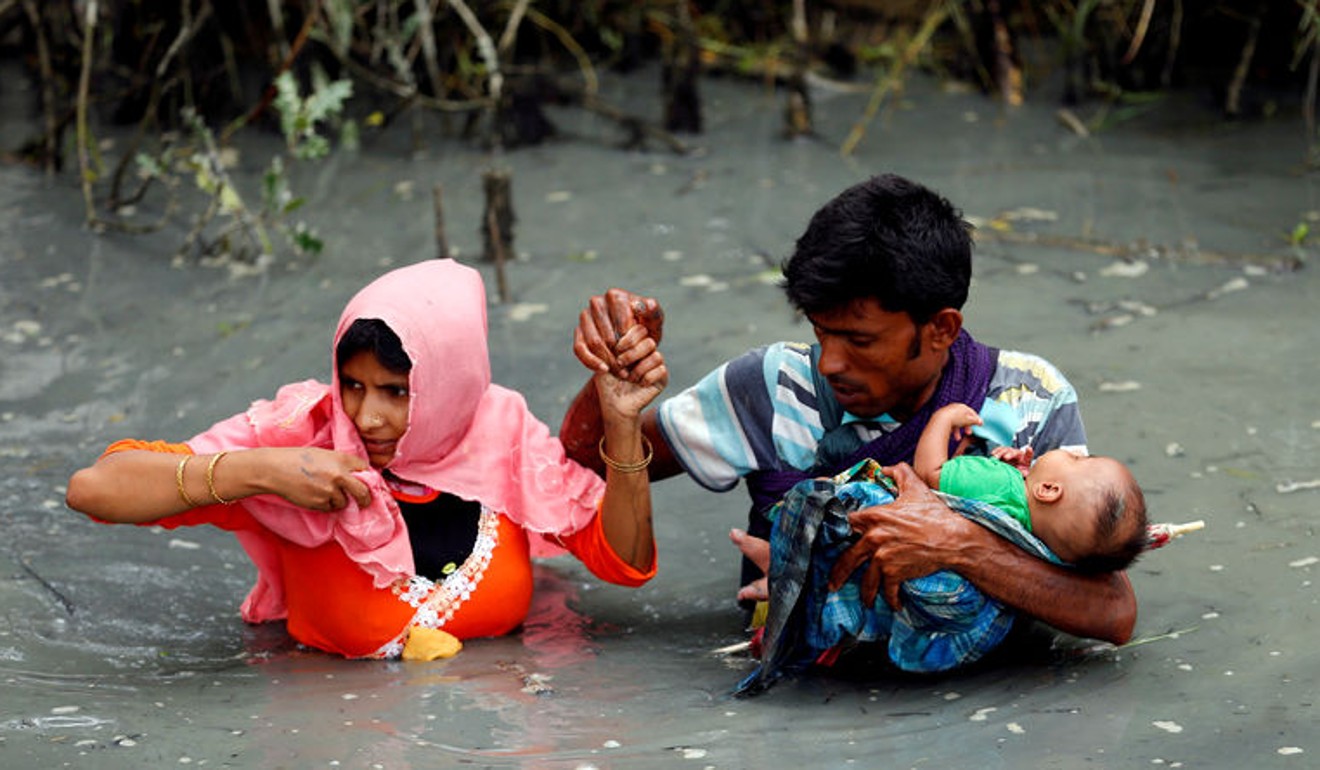 Ethnic cleansing against the Rohingya minority has put Myanmar on the “no-go” list. Here, refugees carry their child as they walk through a flooded stream after crossing the border by boat through the Naf River in Teknaf, Bangladesh. Photo: Reuters
