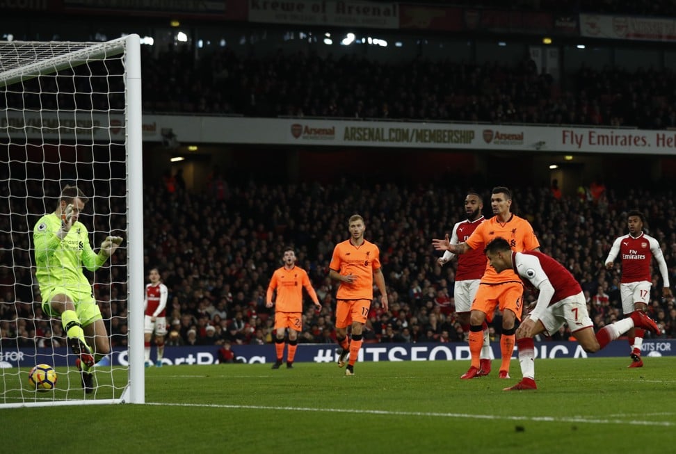 Alexis Sanchez (right) scores Arsenal’s first goal against Liverpool in a 3-3 draw. Liverpool had led 2-0 but their defensive woes were punished again. Photo: AFP