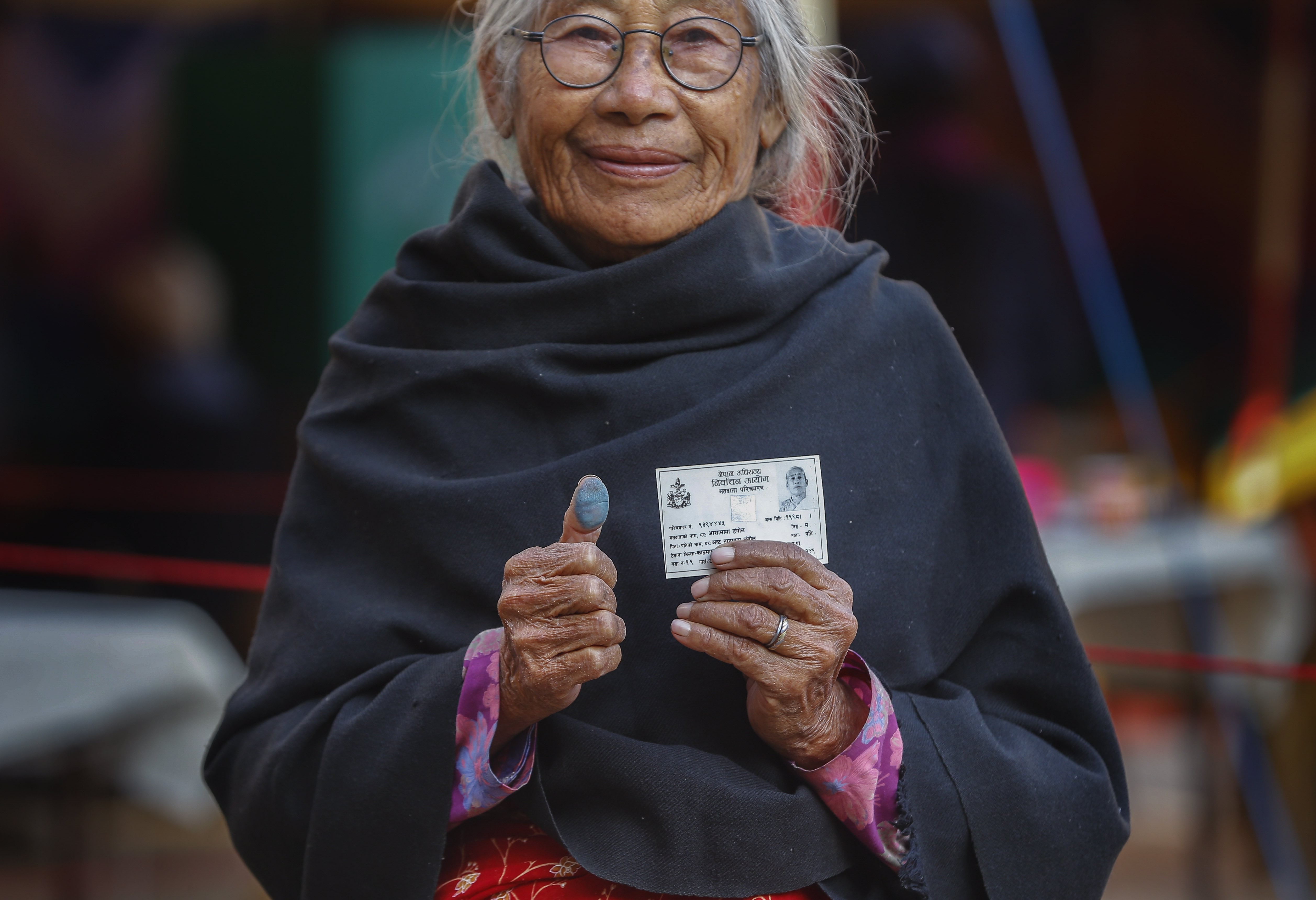 Asha Maya Dangol, 80, shows her thumb print after casting her vote in Kathmandu, in the elections on December 7. Nepal's leftist alliance prevailed in the elections. After two decades of conflict and political stability, Nepalis hope the alliance can deliver stable governance and economic development. Photo: EPA-EFE