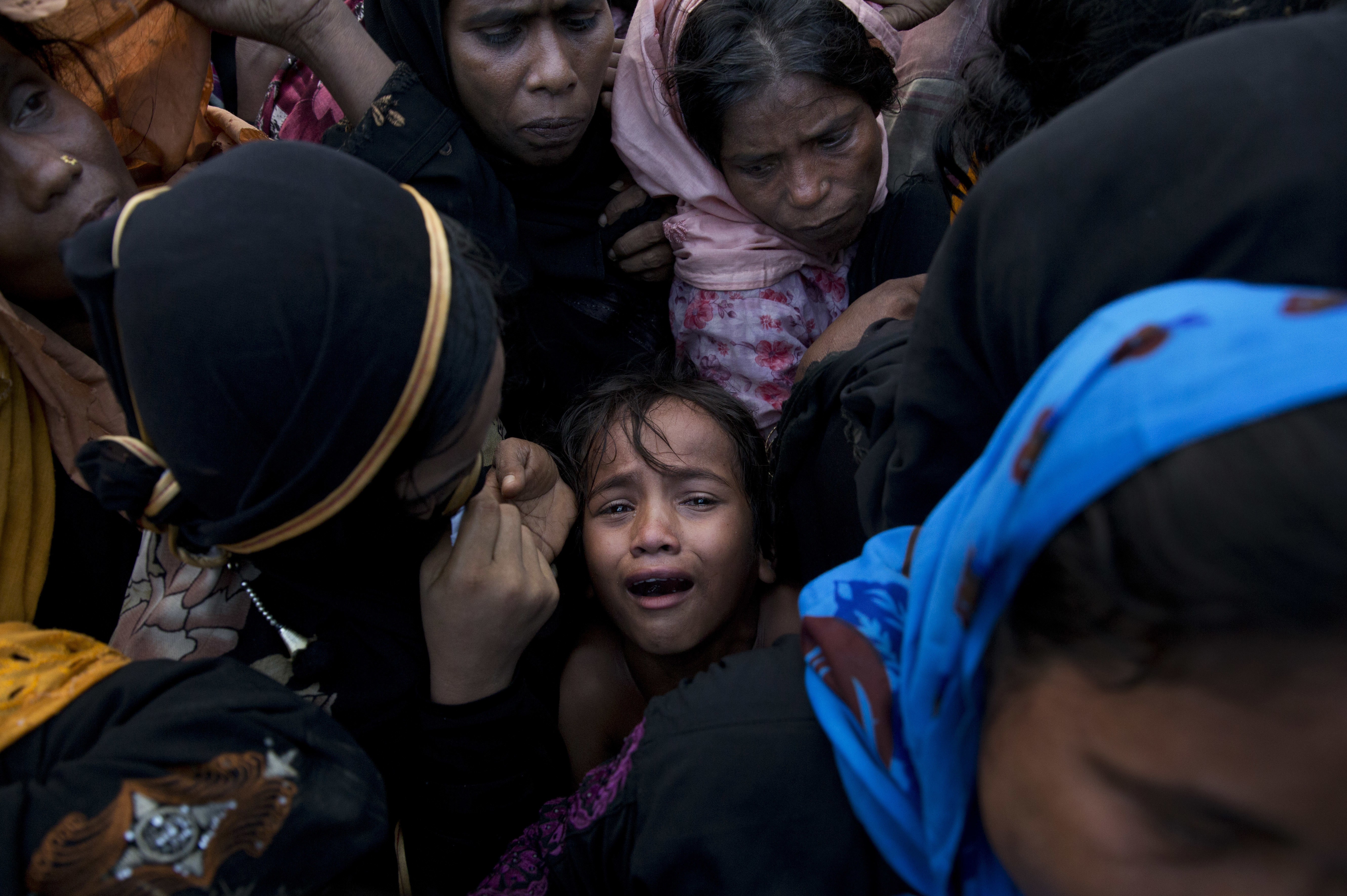 A Rohingya Muslim child cries as she stands amid a crowd receiving food rations near a refugee camp in Cox's Bazar, Bangladesh in September. Photo: AP