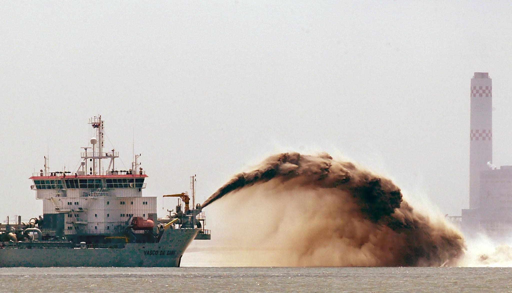 A vessel spews Indonesian sand in Singapore, the world’s biggest importer of sand. Photo: AFP