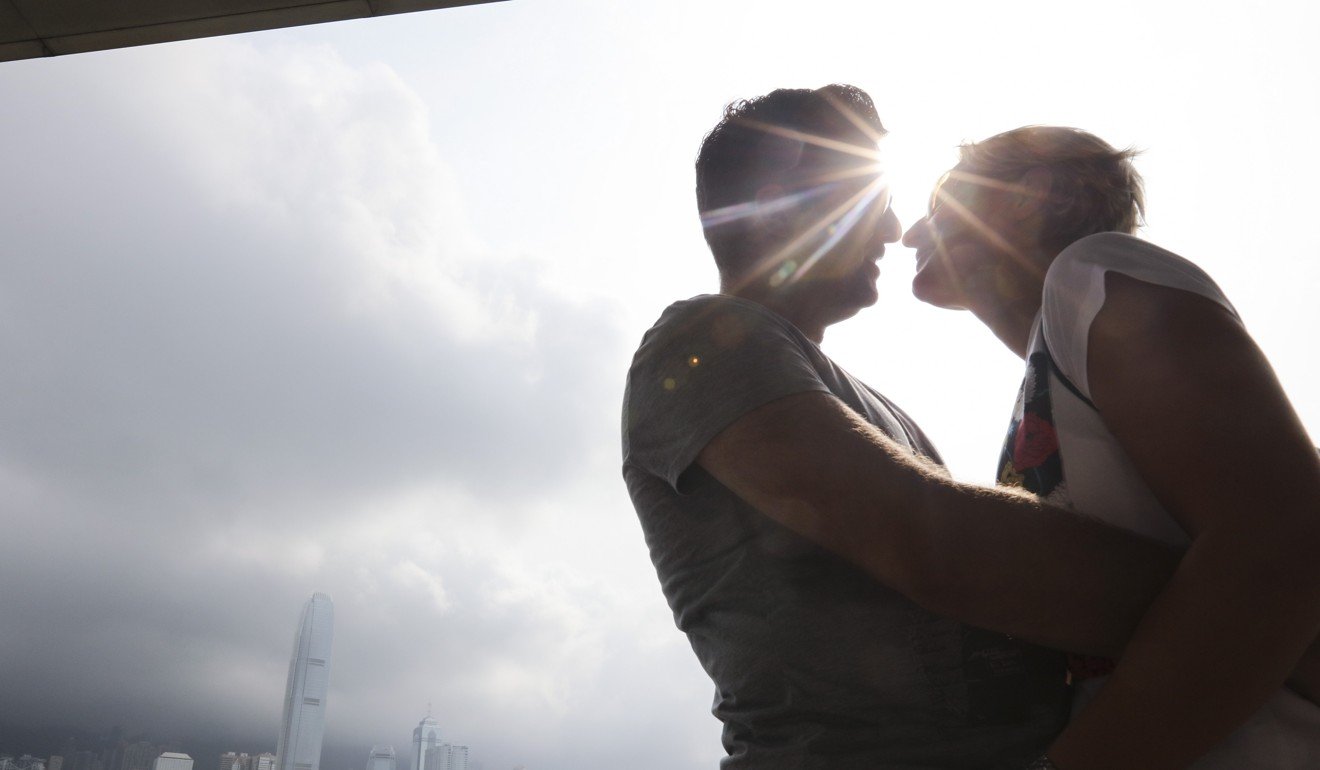 A couple kiss during a hot day at Victoria Harbour in Tsim Sha Tsui. Photo: Felix Wong