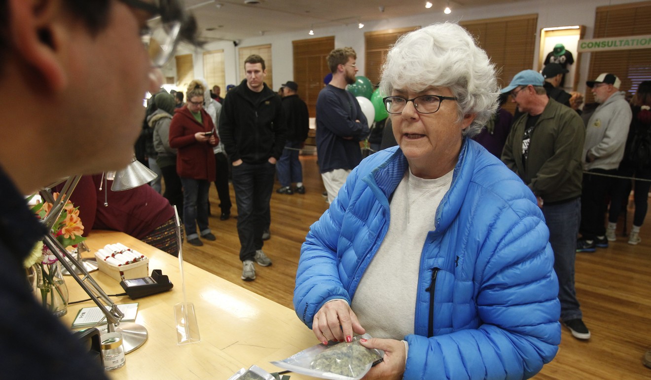Margot Simpson, right, purchases marijuana at Harborside. Starting New Year's Day, recreational marijuana can be sold legally in California. Photo: AP