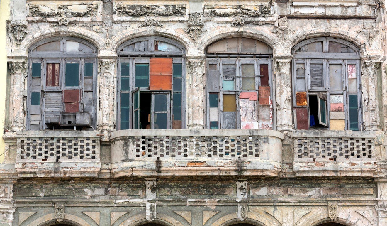 A typically weather-beaten house front along the Malecon in Havana. Picture: Alamy
