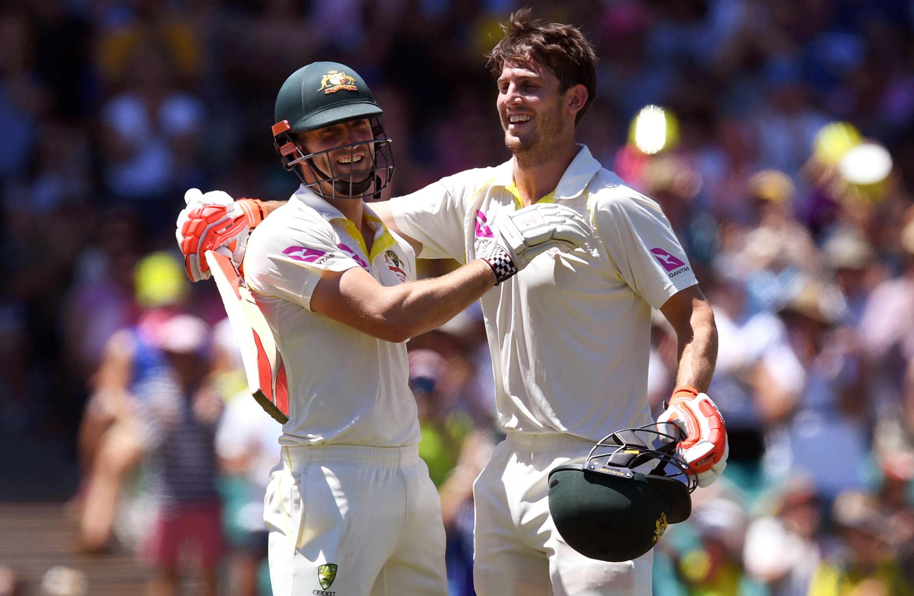 Australia's Mitch Marsh (right) celebrates scoring his century with brother Shaun. Photo: AFP