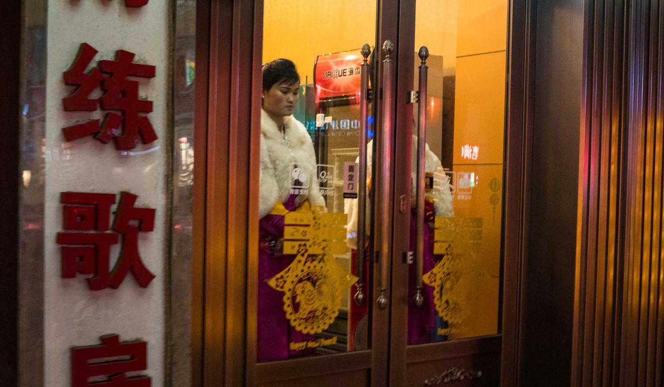 A worker waits at the entrance of a North Korean restaurant in Shenyang. Photo: AFP