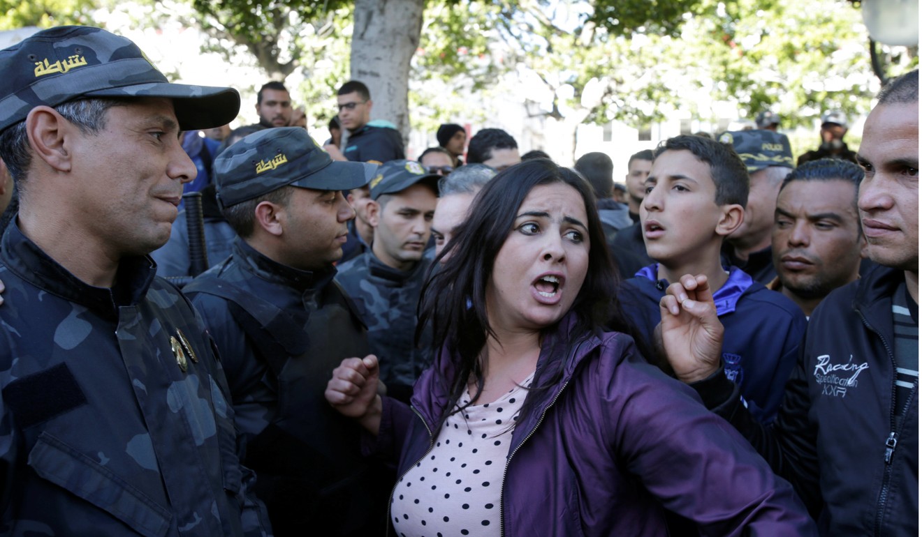 A woman shout slogans during demonstrations in Tunis on the seventh anniversary of a popular uprising in Tunis. Photo: Reuters