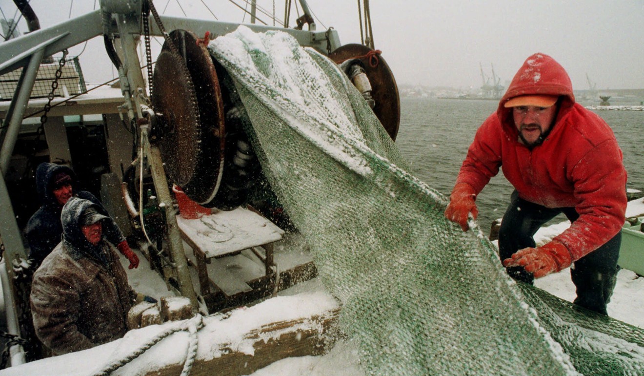 Fisherman Joe Murphy, of Dover, New Hampshire, right, works to gather a net in a 1999 file photo of fishermen in the New England region. Photo: AP