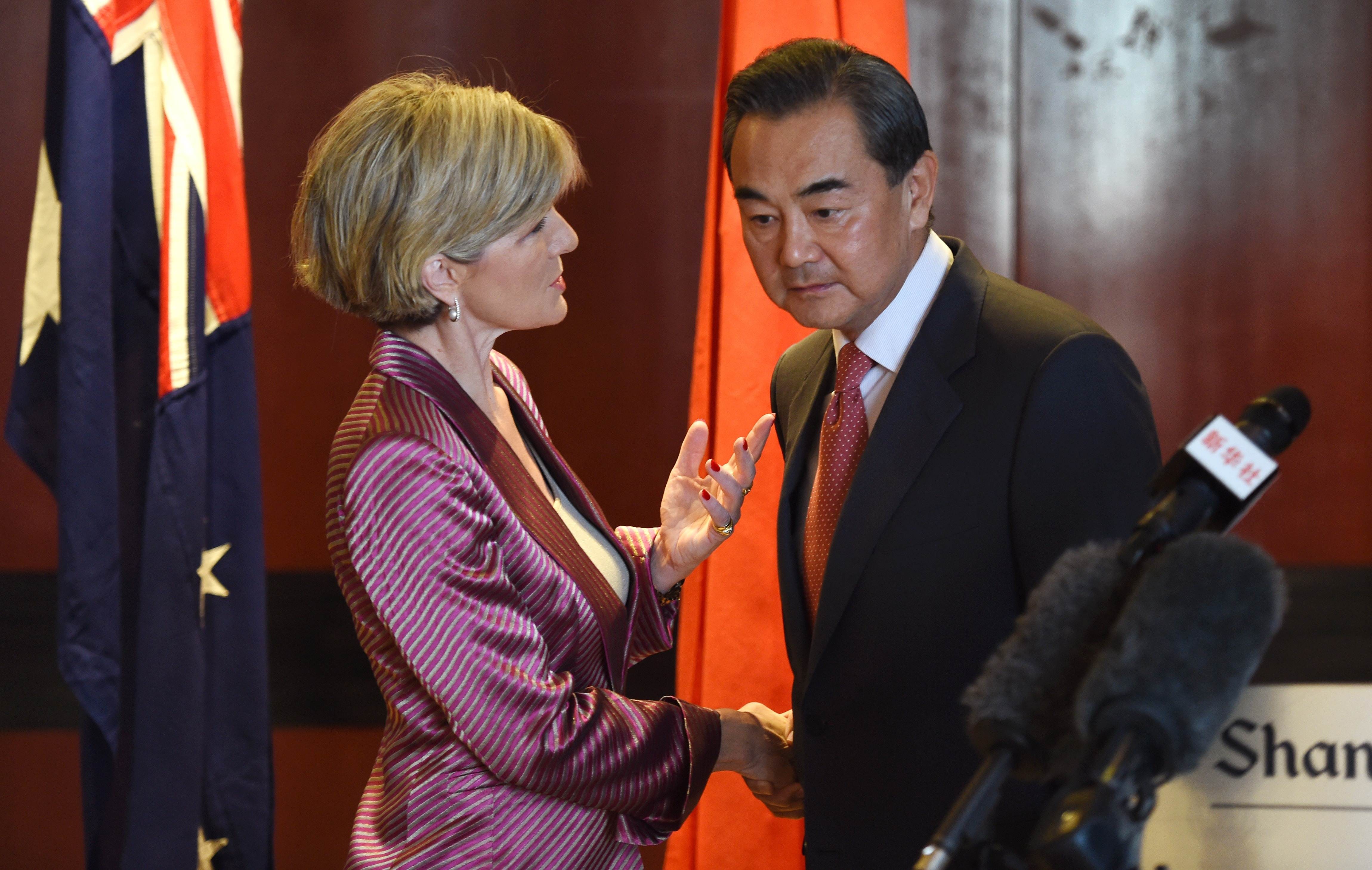 Australian Minister for Foreign Affairs Julie Bishop and Chinese Foreign Minister Wang Yi shake hands in Sydney on September 7, 2014. Photo: AFP