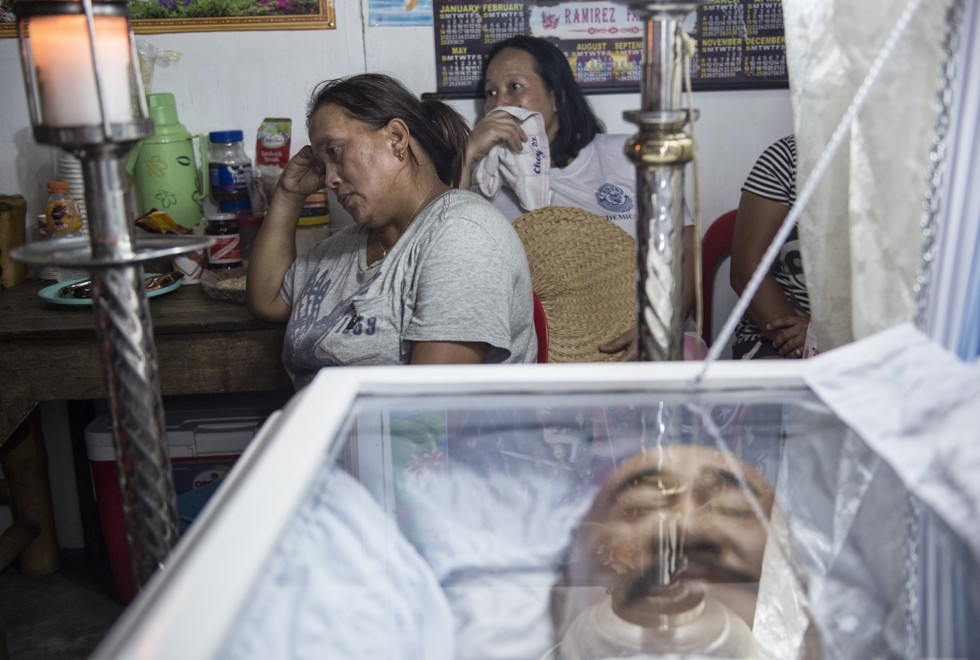 Victoria Ramirez at the wake of her husband, Carlito, who was killed on December 11 last year, a week after the couple’s only daughter and her husband had been gunned down in the same way. 