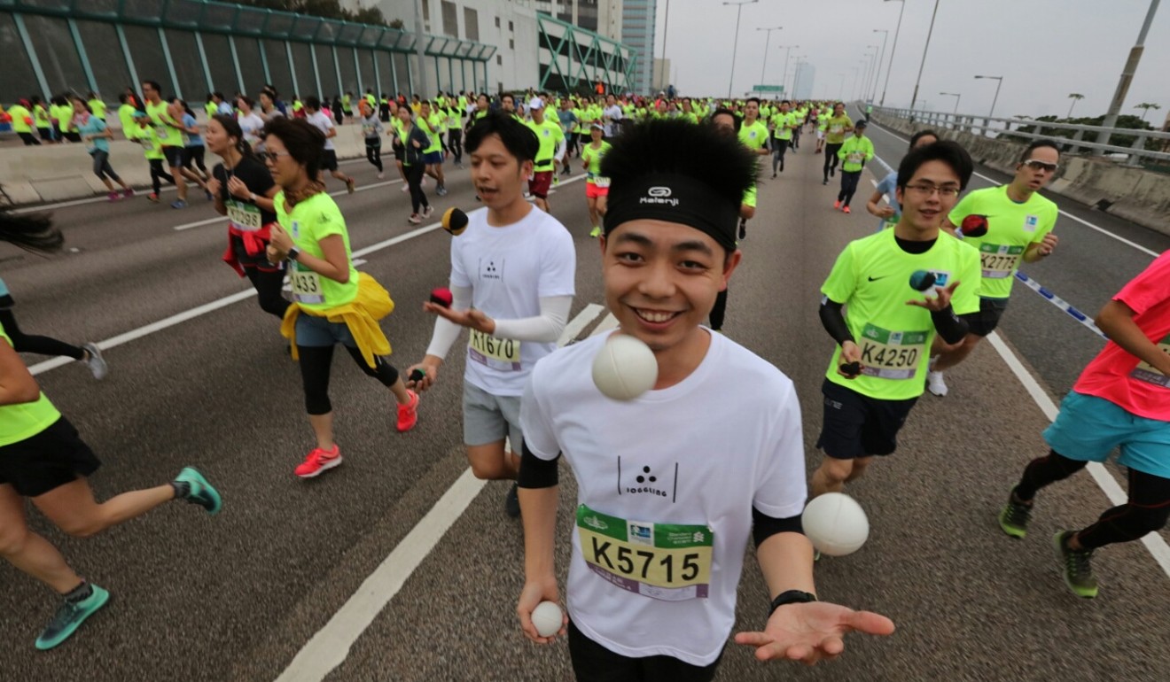 Some runners juggled while they ran in the Hong Kong Marathon. Photo: Felix Wong