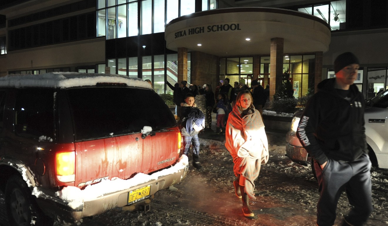 People return home from Sitka High School after getting the all clear. Photo: AP