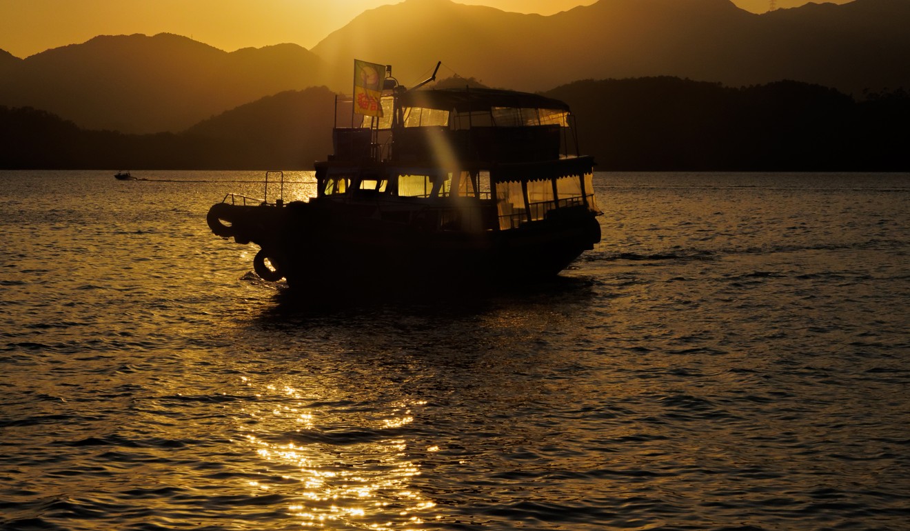 A kaito boat approaches Sharp Island near sunset. Photo: Martin Williams