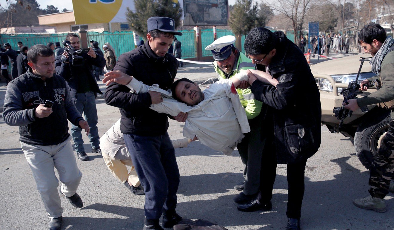 People carry an injured man from the blast. Photo: Reuters