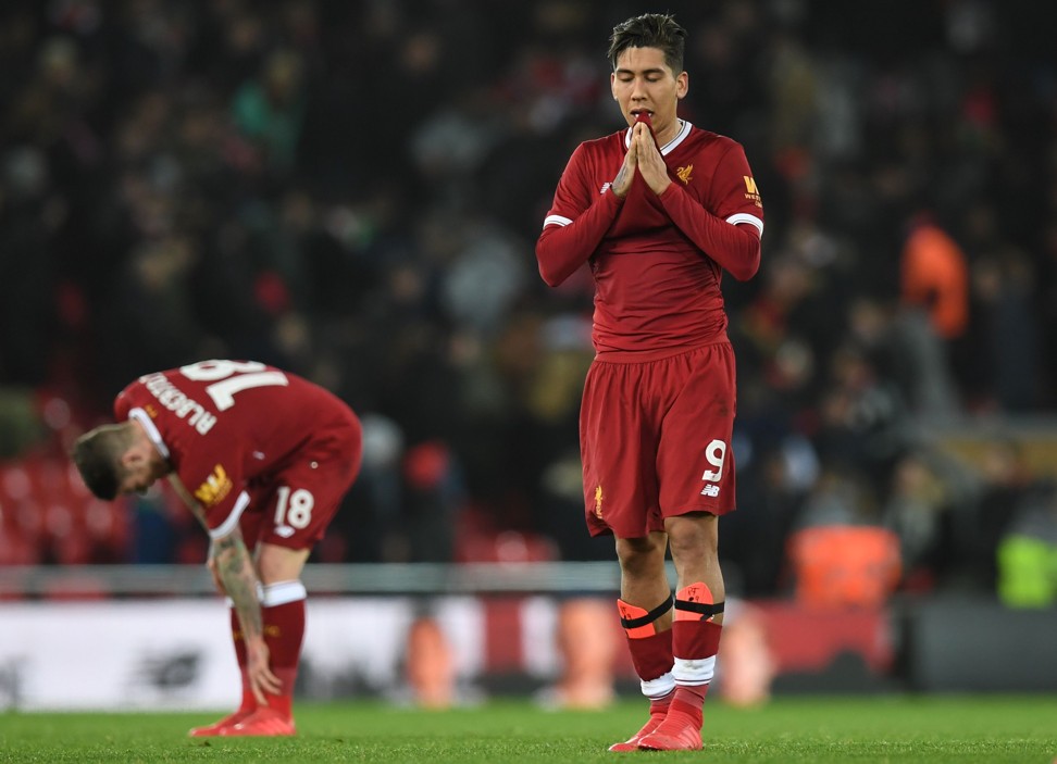 Liverpool’s Roberto Firmino reacts at the final whistle. Photo: AFP
