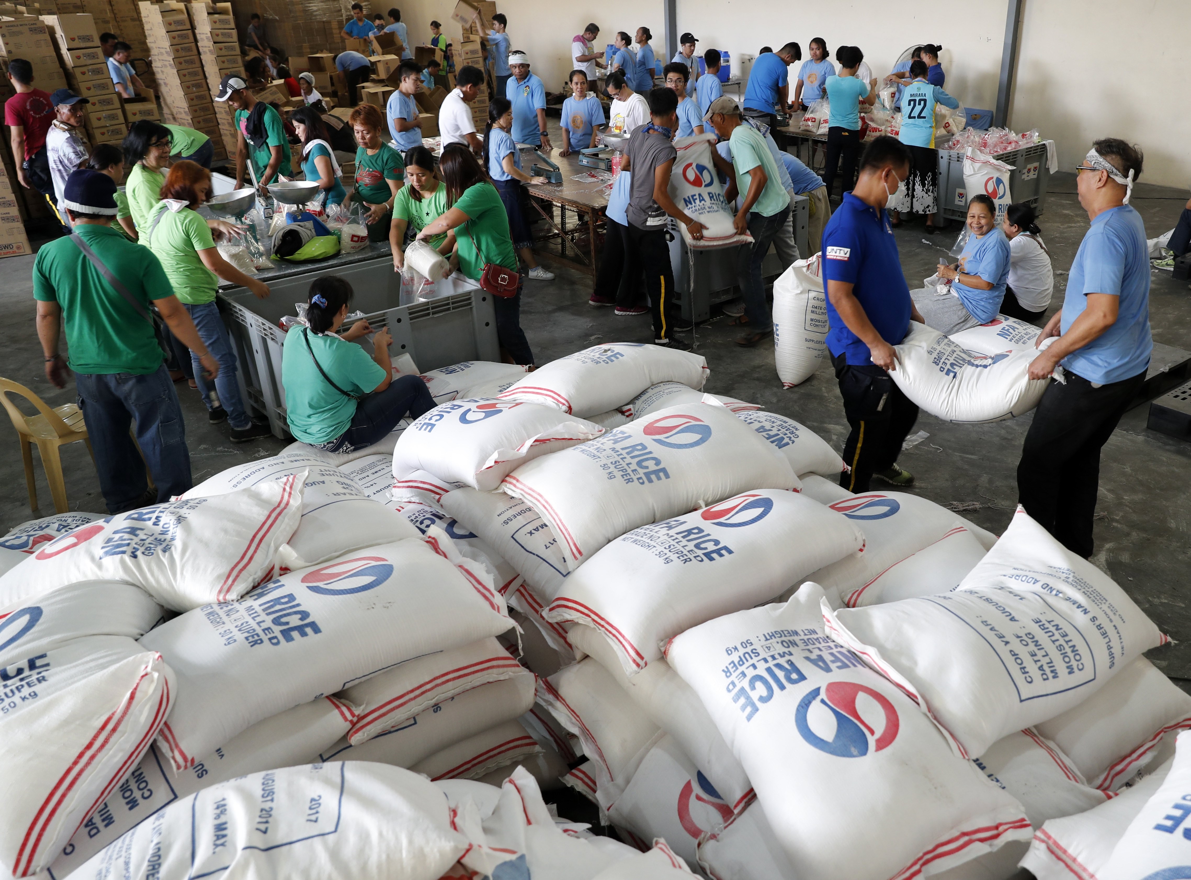Volunteers in Pasay City in the Philippines repack relief goods for families affected by a typhoon, at a government storage facility. While the social ecosystem surrounding philanthropy in Asia is robust, governments could do more to encourage systematic giving. Photo: EPA