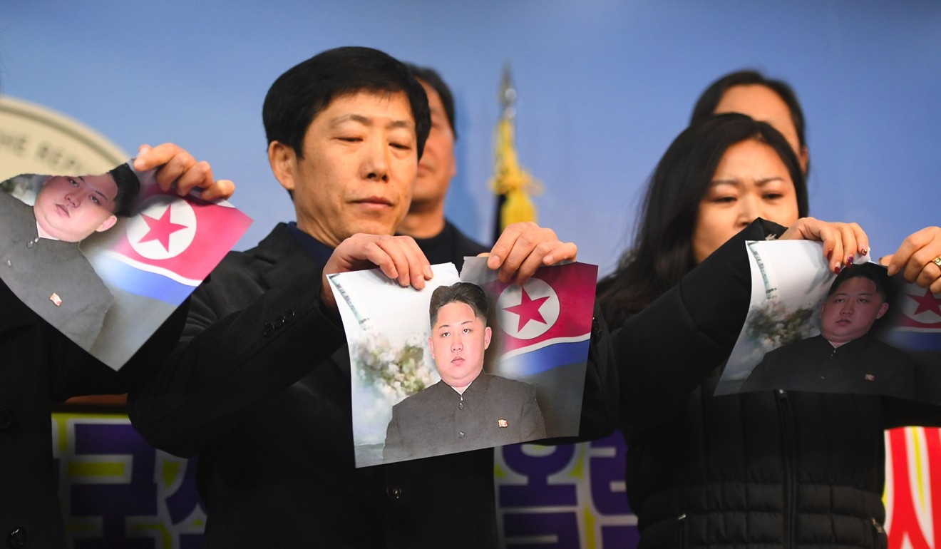 North Koreans who defected to the South tear pictures of North Korean leader Kim Jong-Un during a press conference against the North's attendance at the Pyeongchang Olympics, at the National Assembly in Seoul on Wednesday. South Korea's efforts to bring the North to its Winter Olympics in Pyeongchang next month are provoking a backlash among its own people, with accusations that Seoul risks turning the Games into a “Pyongyang Olympics”. File photo: Agence France-Presse