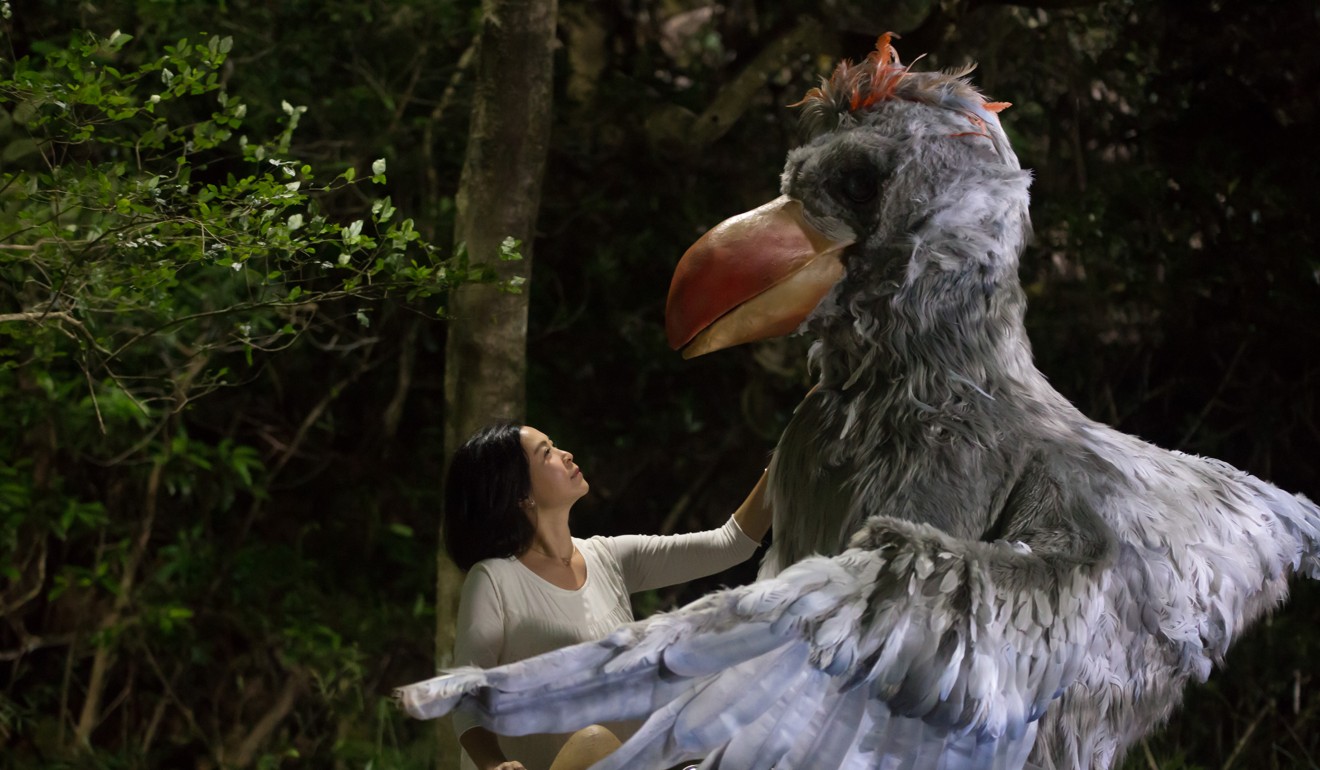 Louisa So and the giant bird in a still from Staycation.