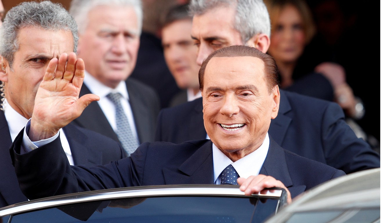 Silvio Berlusconi waves as he leaves after taking part in a television talk show in Rome on January 18. Photo: Reuters