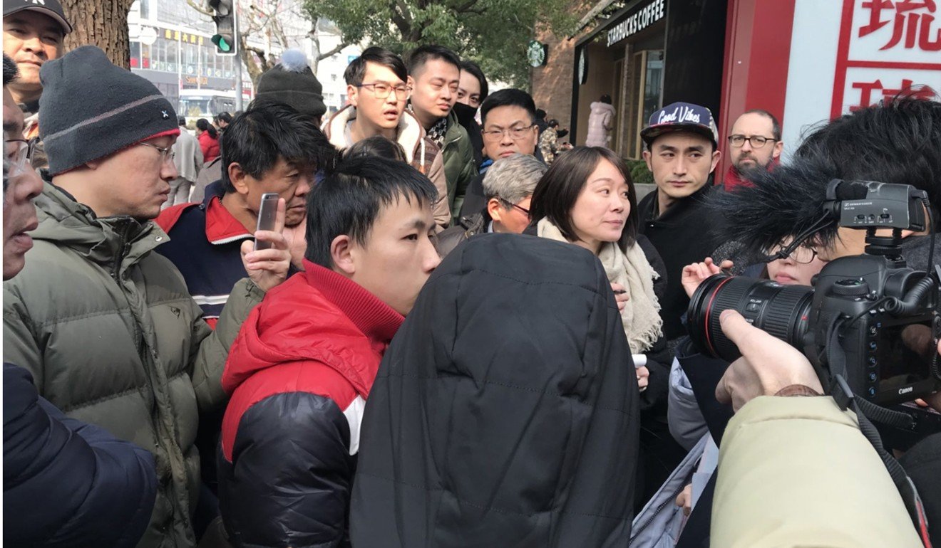 Xu Xin (in red) speaks to reporters after the crash. He was jogging down West Nanjing Road when it happened. Photo: Daniel Ren