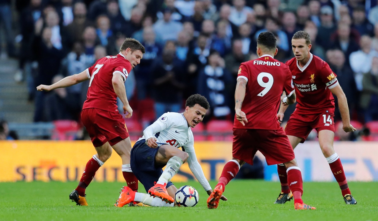 Tottenham’s Dele Alli in action with Liverpool’s James Milner, Jordan Henderson and Firmino. Photo: Reuters