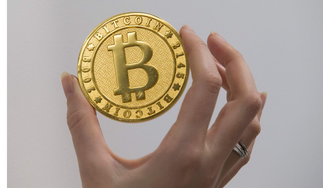 A token depicting the digital cryptocurrency bitcoin, at La Maison du Bitcoin in Paris. Photo: AFP
