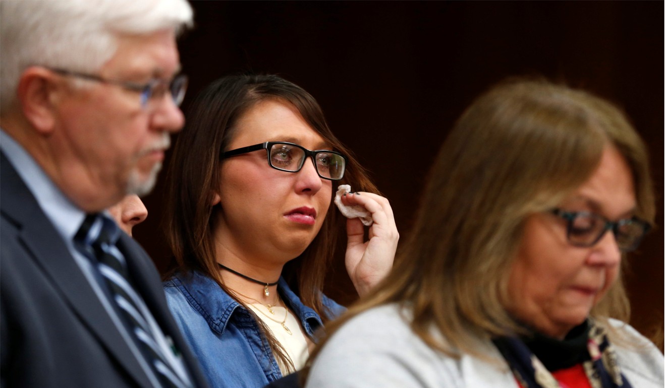 Ashley Erickson (C) cries as her parents read a victim's statement for her during the sentencing hearing of Larry Nassar in the Eaton County Court in Charlotte, Michigan on February 2, 2018. Photo: Reuters