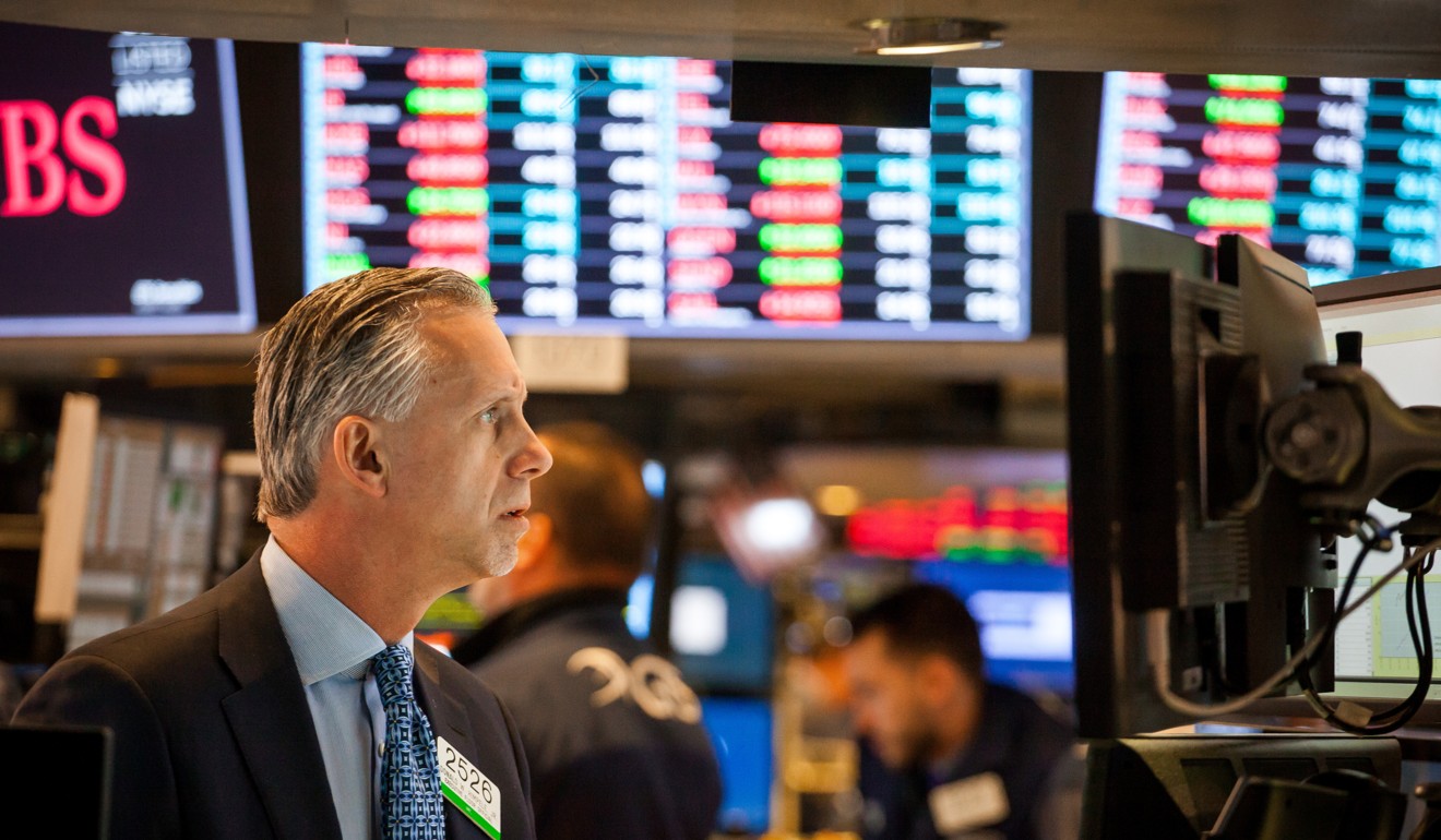 A trader at the New York Stock Exchange eyes volatile stocks in the market. Photo: Bloomberg