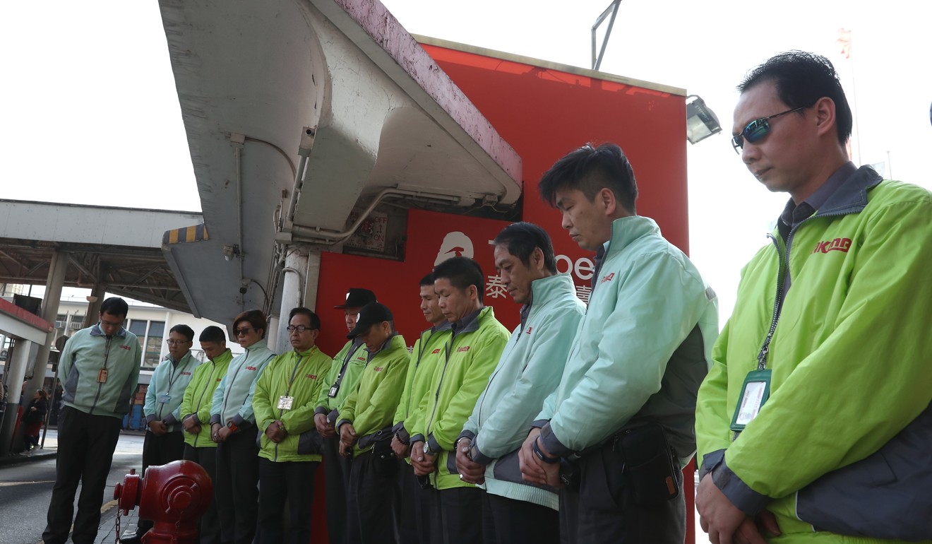 Staff from KMB at the Star Ferry Pier Bus Terminus in Tsim Sha Tsui during a moment of silence in tribute to the bus crash victims. Photo: Nora Tam